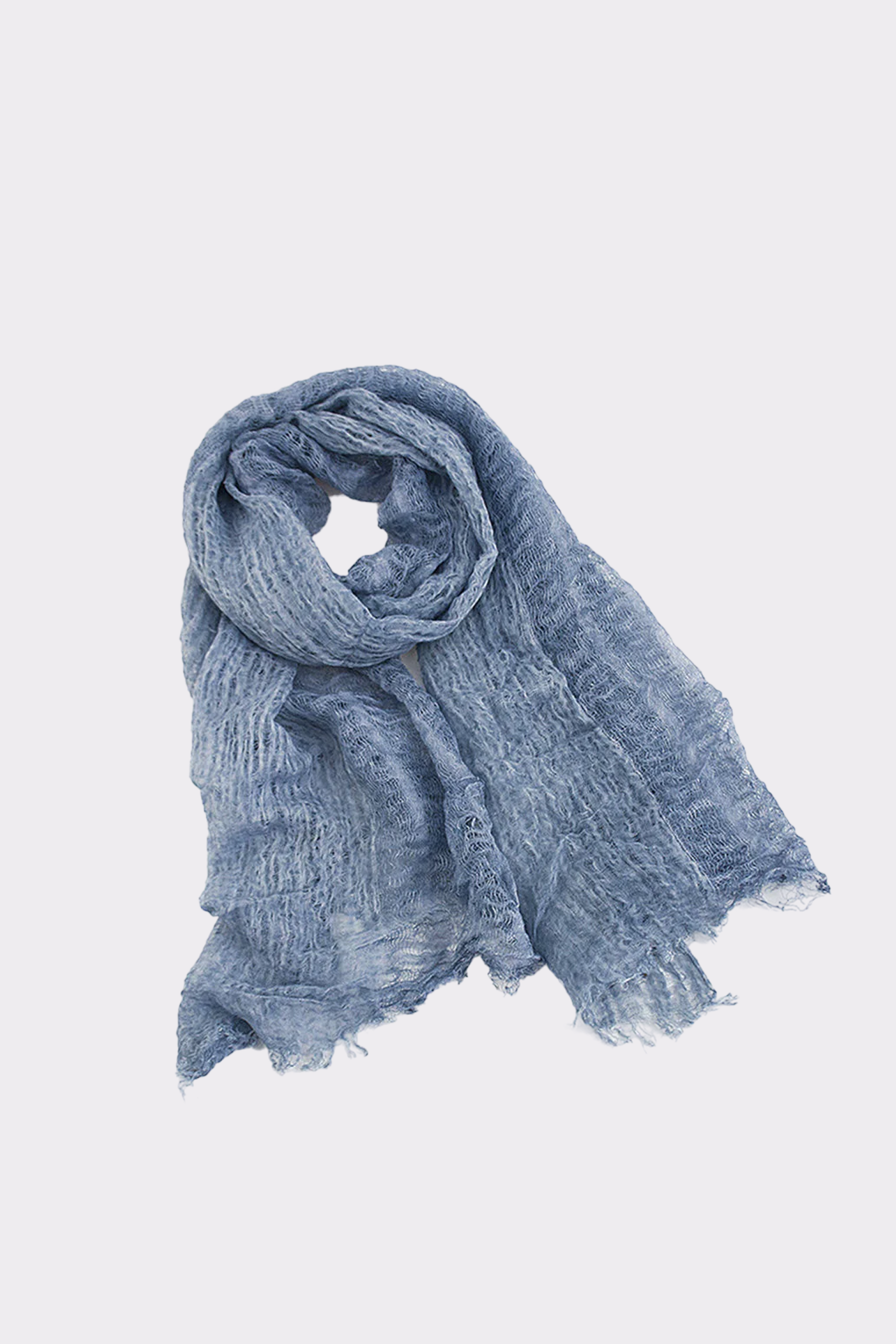 The Lightweight Linen Scarf, in light blue textured linen with frayed edges and a softly crinkled finish, is ultra-breathable and laid loosely rolled on a white background—an effortless, versatile accessory for any outfit.