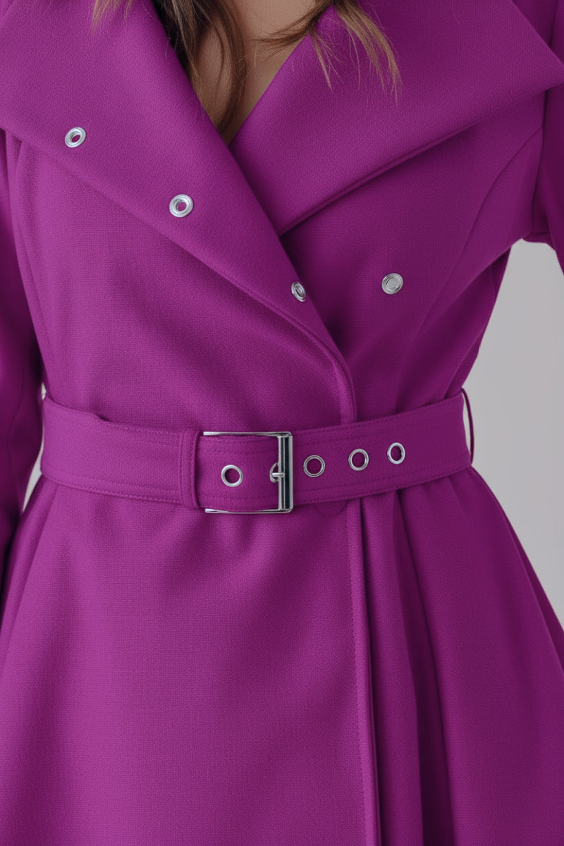 A close-up shows a person wearing the looselyboho Water-Repellent Rain & Shine A-Line Hooded Raincoat in bright purple, featuring large lapels, silver snap buttons, and a fitted waist. The stylish women's raincoat offers both protection and elegance. The face is not visible.